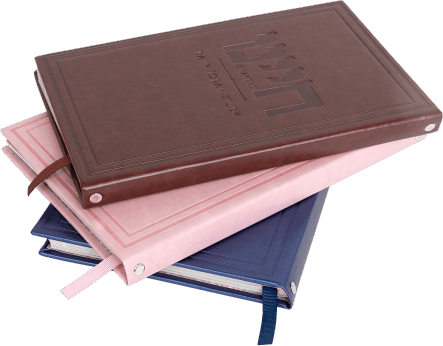 A stack of Chayenu PU leather slip covers in brown, pink, and blue
